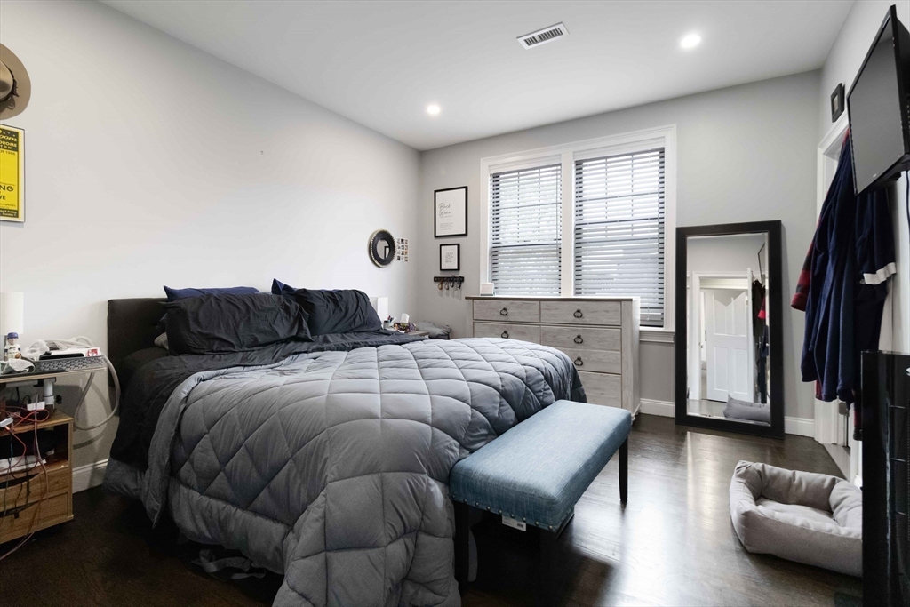 18 Albion Street, Unit 2 Boston, MA 02119 - Photo 6 of 22 a bedroom with a bed and a couch