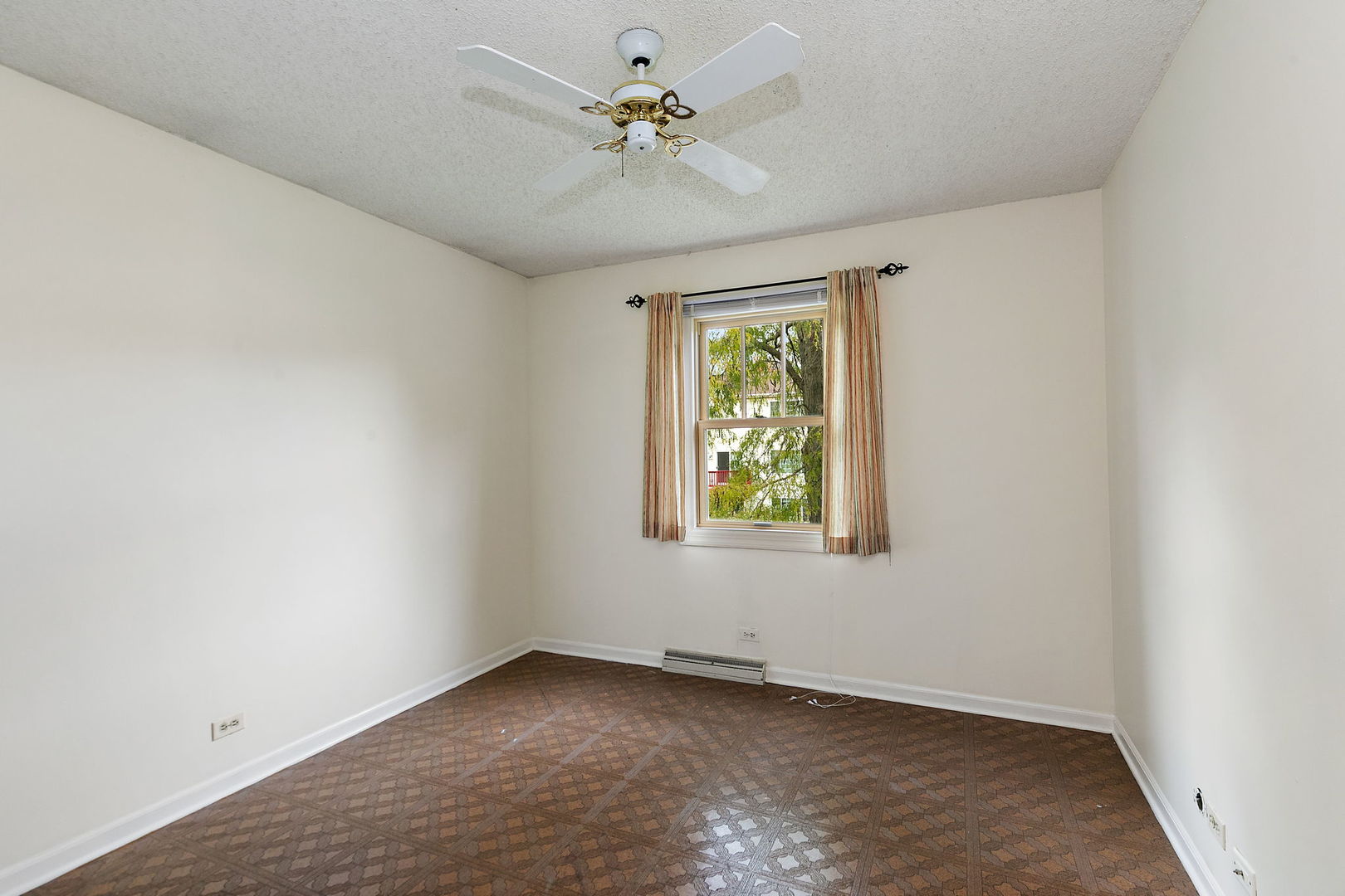 517 Sheffield Road Naperville, IL 60565 - Photo 14 of 29 an empty room with windows and ceiling fan