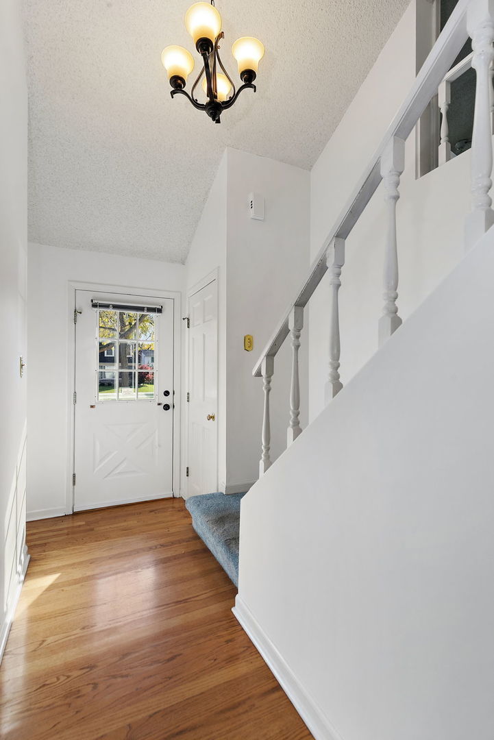 517 Sheffield Road Naperville, IL 60565 - Photo 6 of 29 a view of empty room with wooden floor and fan
