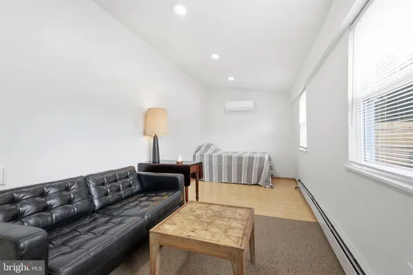 an empty room with a ceiling fan and window