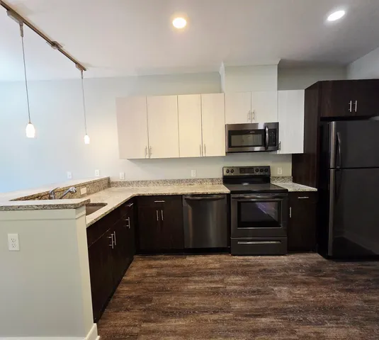 a kitchen with a sink stove and refrigerator