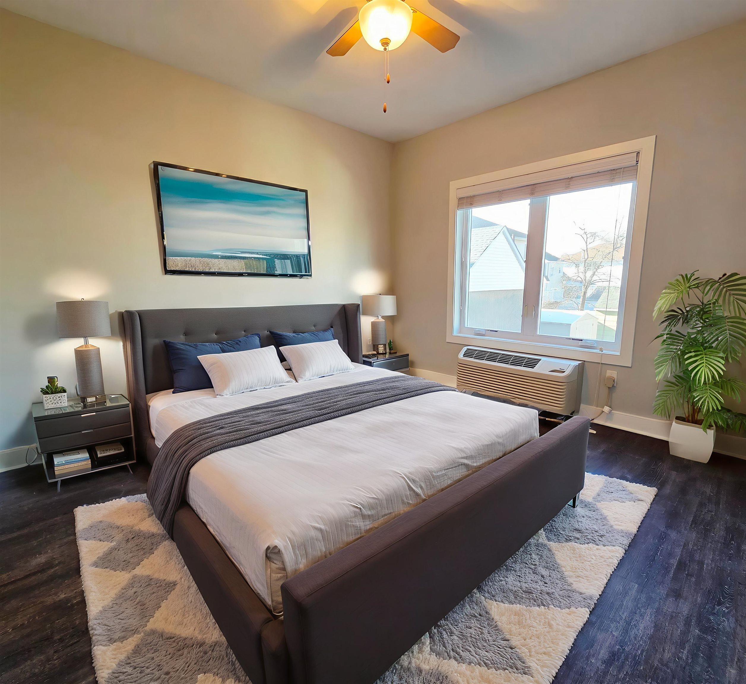 235 Ridge Road, Unit 1C North Arlington, NJ 07031 - Photo 7 of 10 a bedroom with a large bed and a chandelier