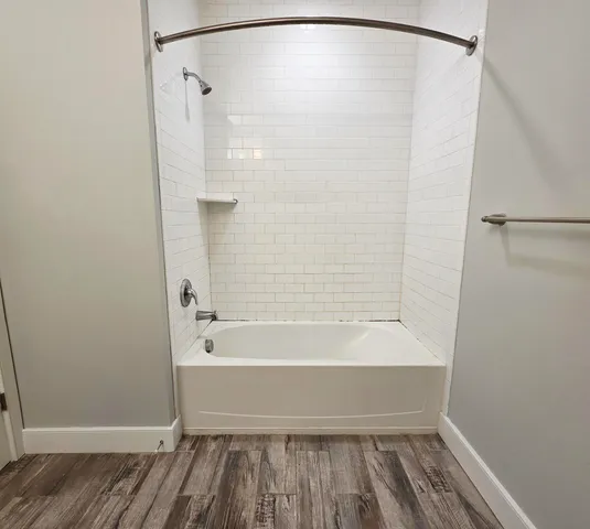 a bathroom with a bathtub and a shower
