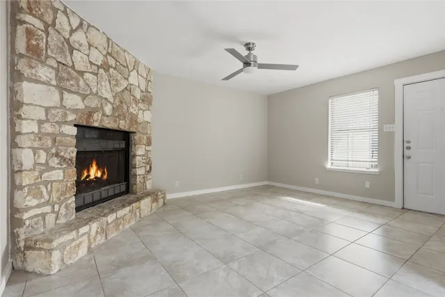 a view of an empty room with a fireplace
