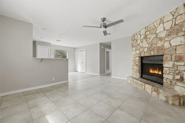 a view of an empty room with a fireplace