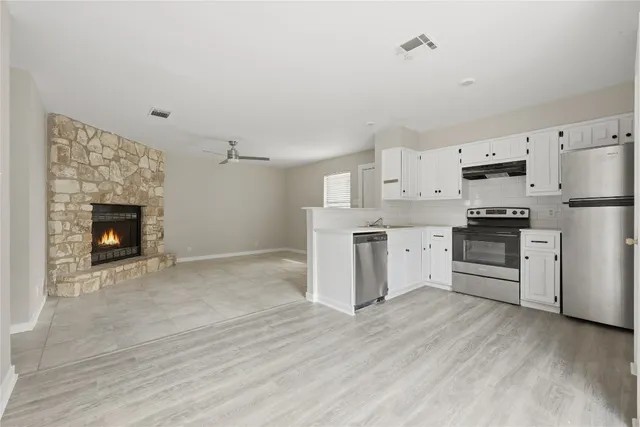 a kitchen with white cabinets and white appliances