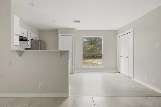a view of a kitchen with an empty space and a window