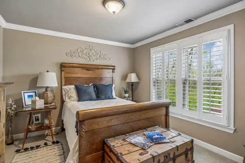 a bedroom with a bed and a chandelier