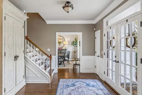 a view of a room with furniture and wooden floor