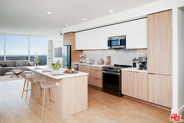 a kitchen with a sink a stove and cabinets