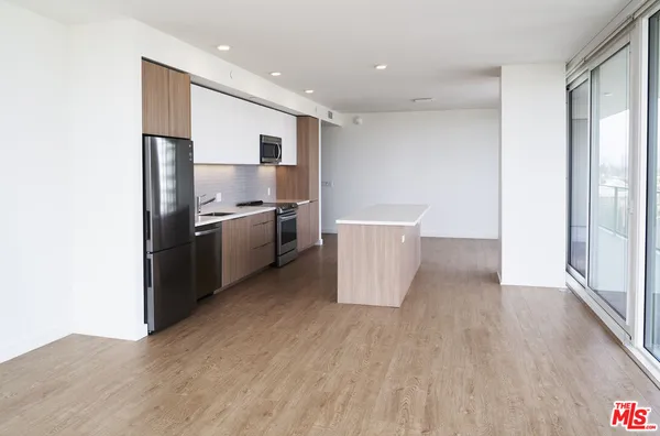 a kitchen with stainless steel appliances a refrigerator and a stove top oven