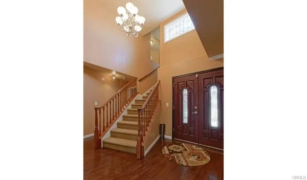 a view of a hallway with entryway wooden floor and front door