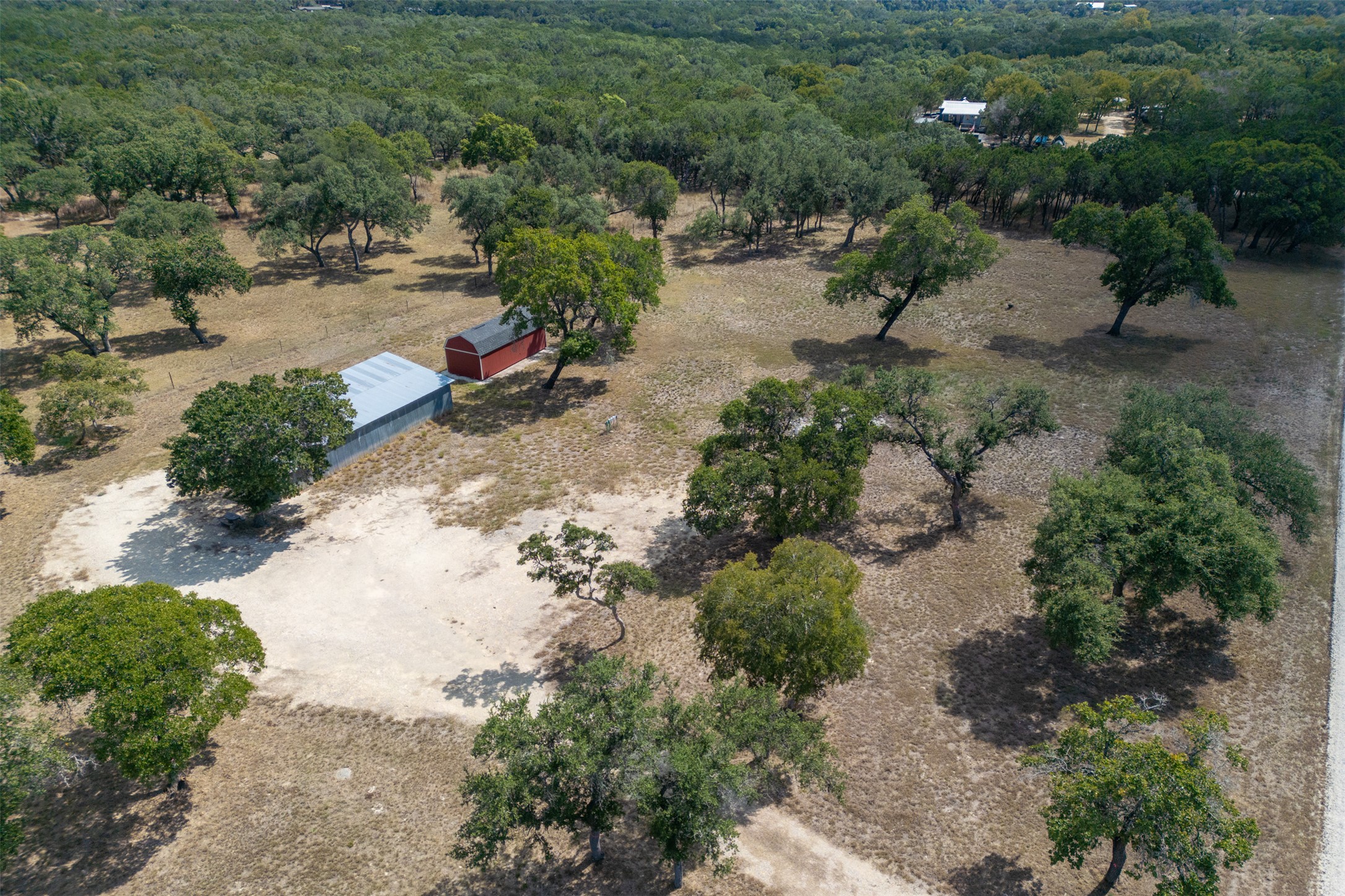 an aerial view of a house with a yard and lake view