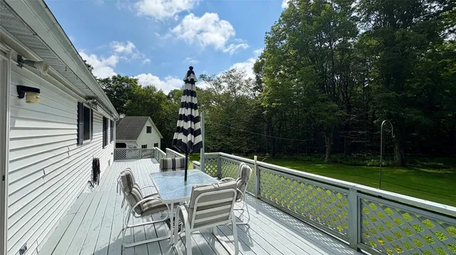 a view of balcony with furniture and trees