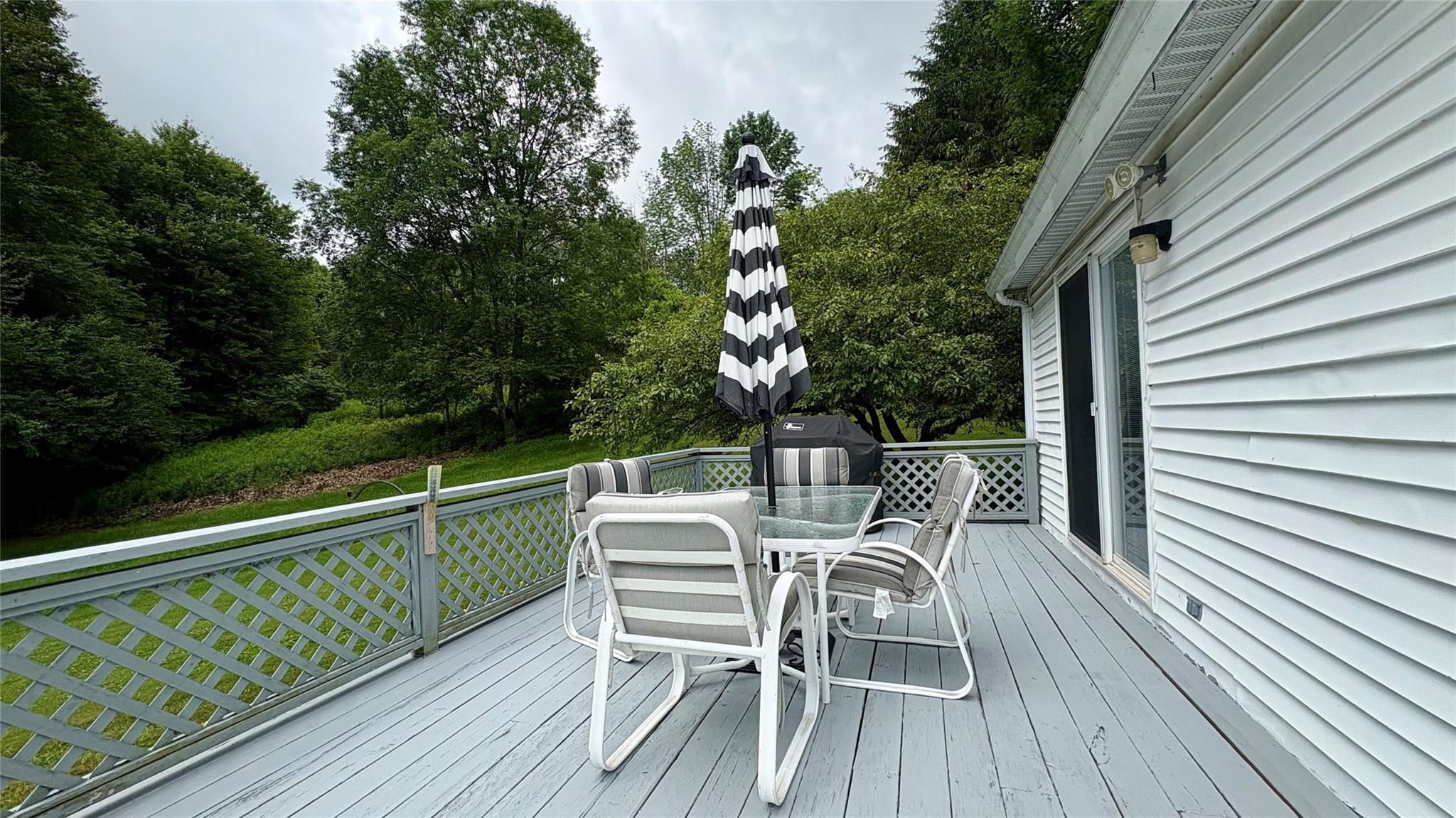 105 White Sulphur Road Swan Lake, NY 12783 - Photo 12 of 42 a view of balcony with furniture and trees
