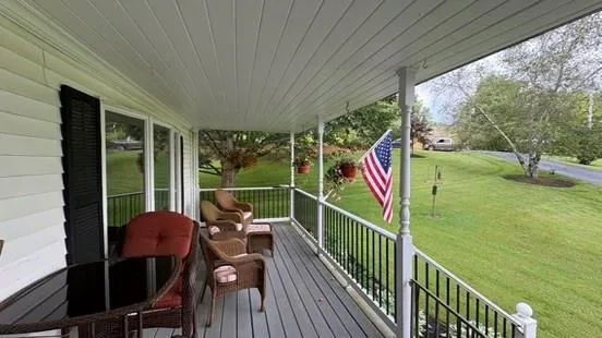 a view of a balcony with yard