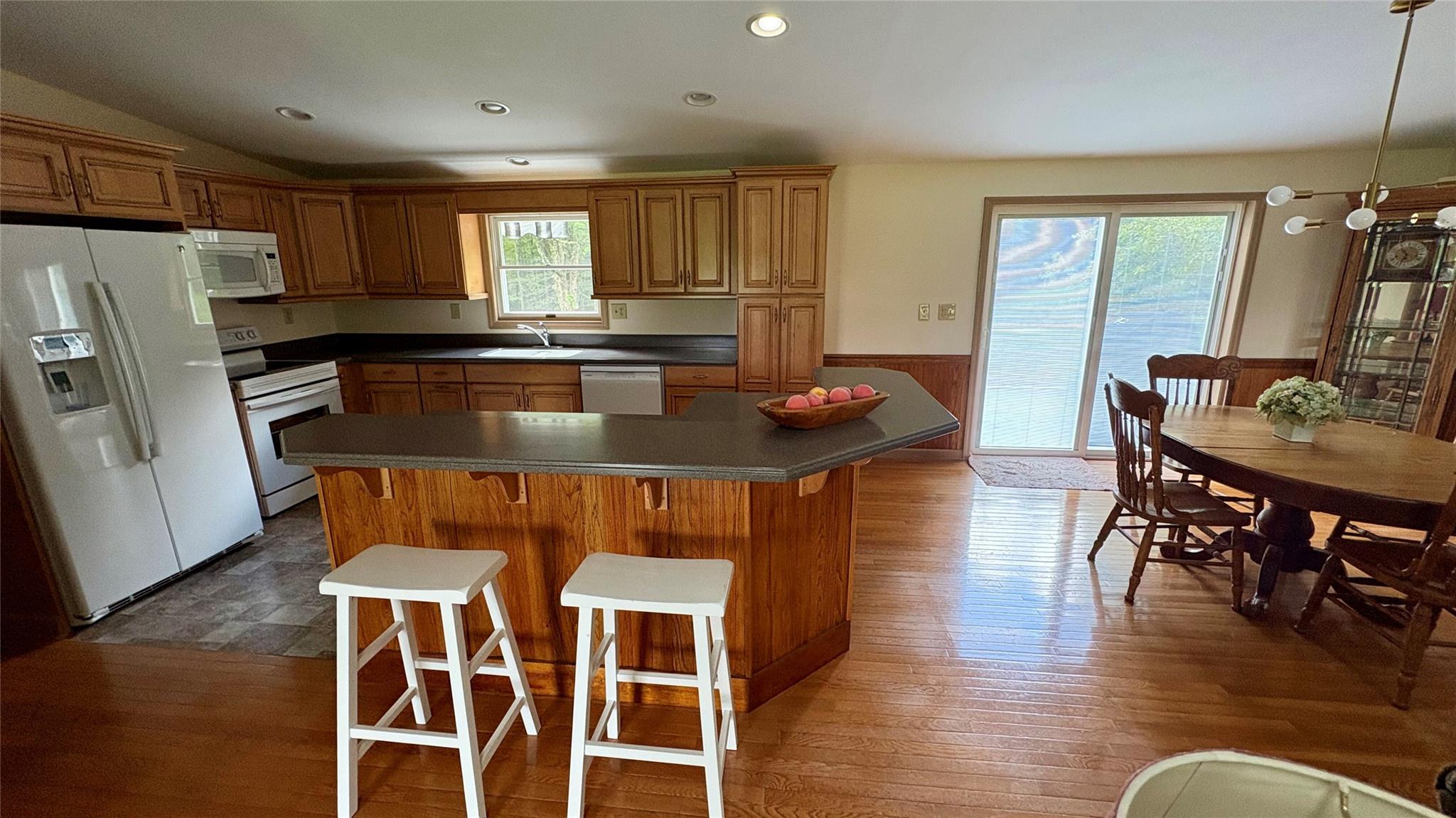 105 White Sulphur Road Swan Lake, NY 12783 - Photo 23 of 42 a kitchen with stainless steel appliances granite countertop a stove a refrigerator a dining table and chairs