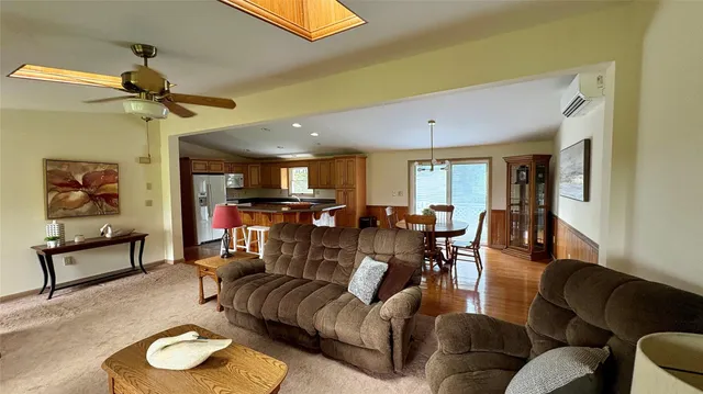 a kitchen with stainless steel appliances granite countertop a sink a stove a refrigerator a counter space and a window