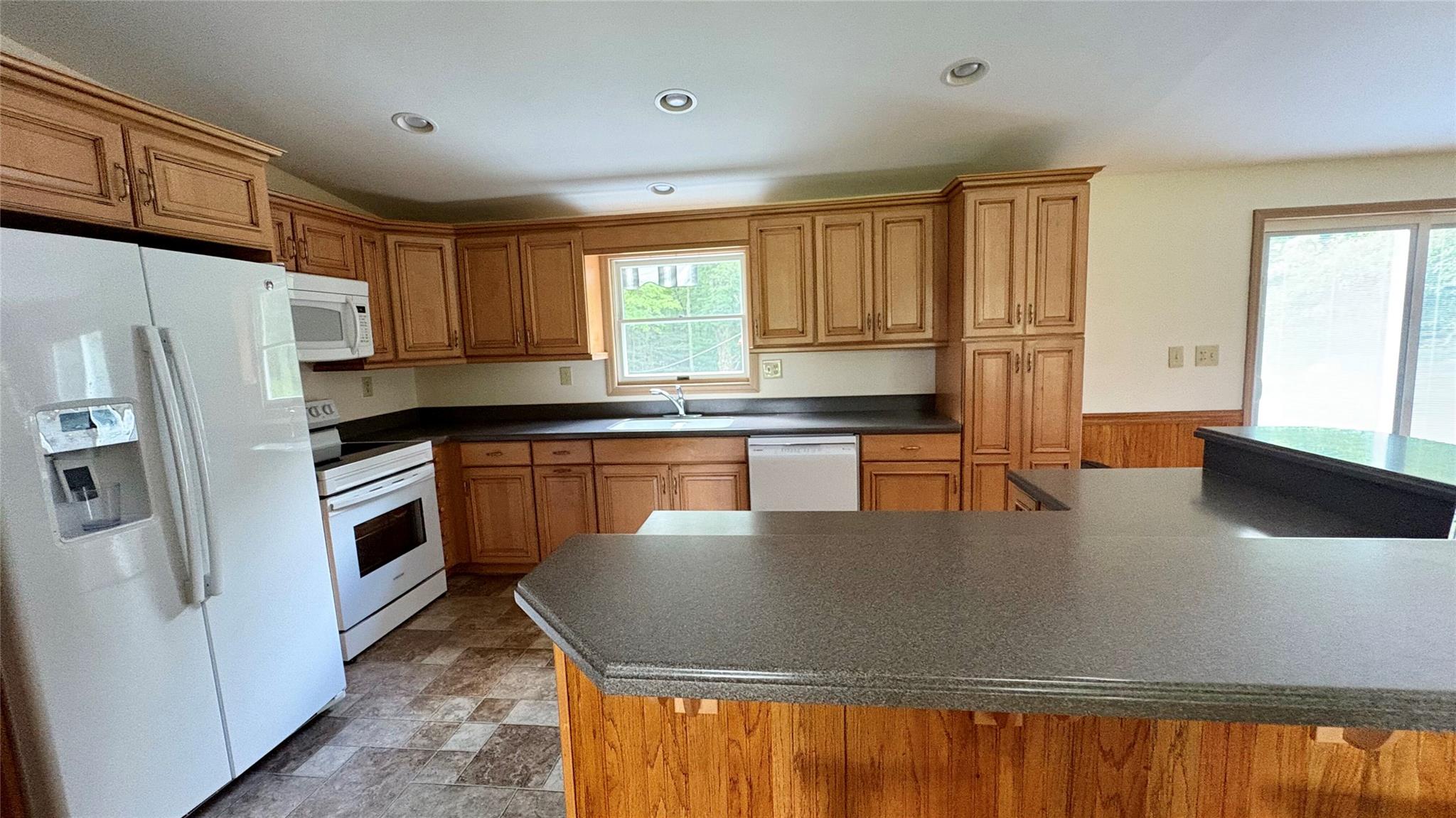 105 White Sulphur Road Swan Lake, NY 12783 - Photo 25 of 42 a kitchen with stainless steel appliances granite countertop a sink a stove a refrigerator a counter space and a window