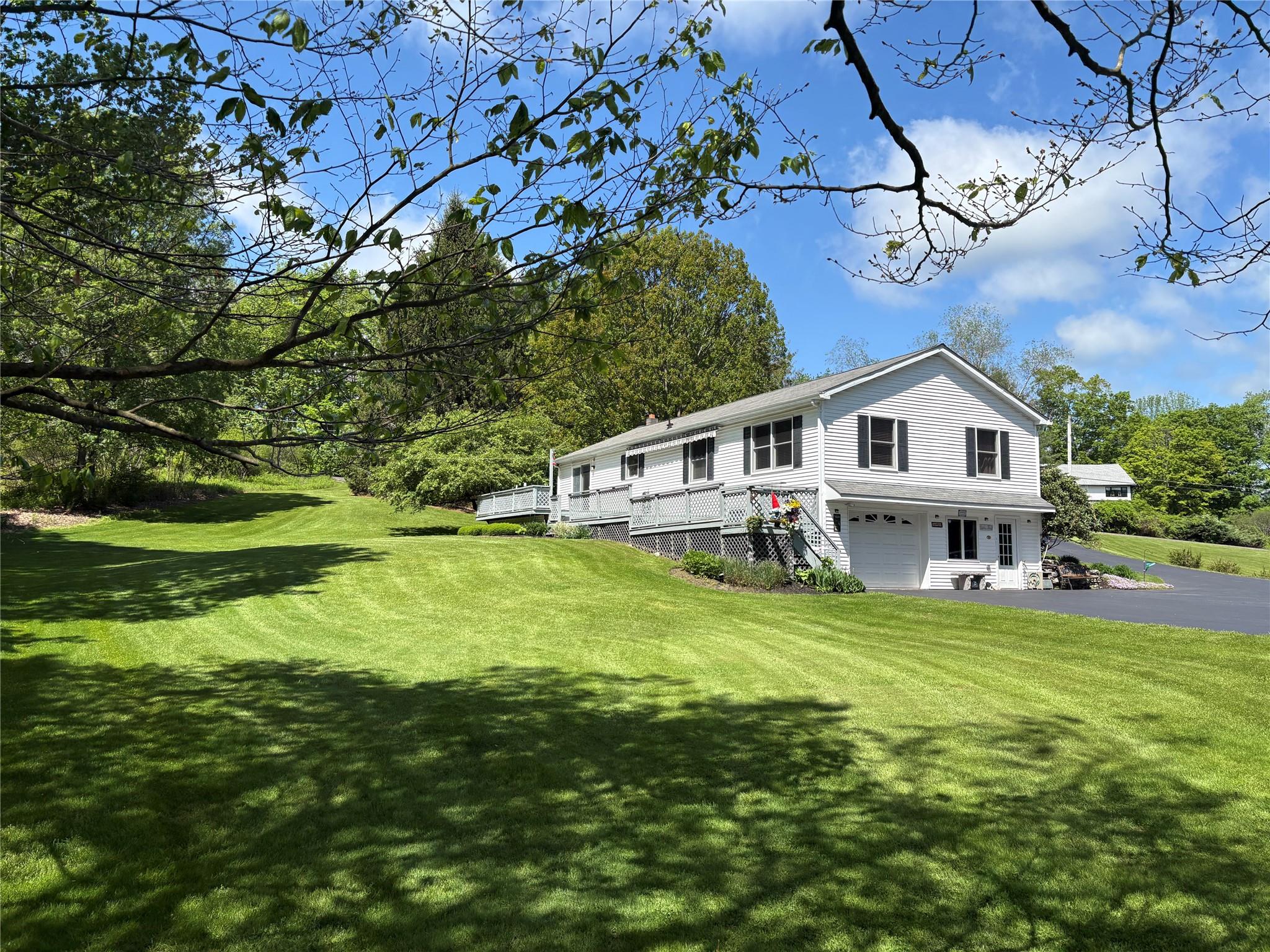 105 White Sulphur Road Swan Lake, NY 12783 - Photo 3 of 42 a white house with a big yard plants and large trees