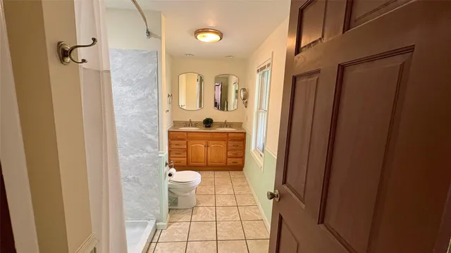 a bathroom with a toilet and a shower