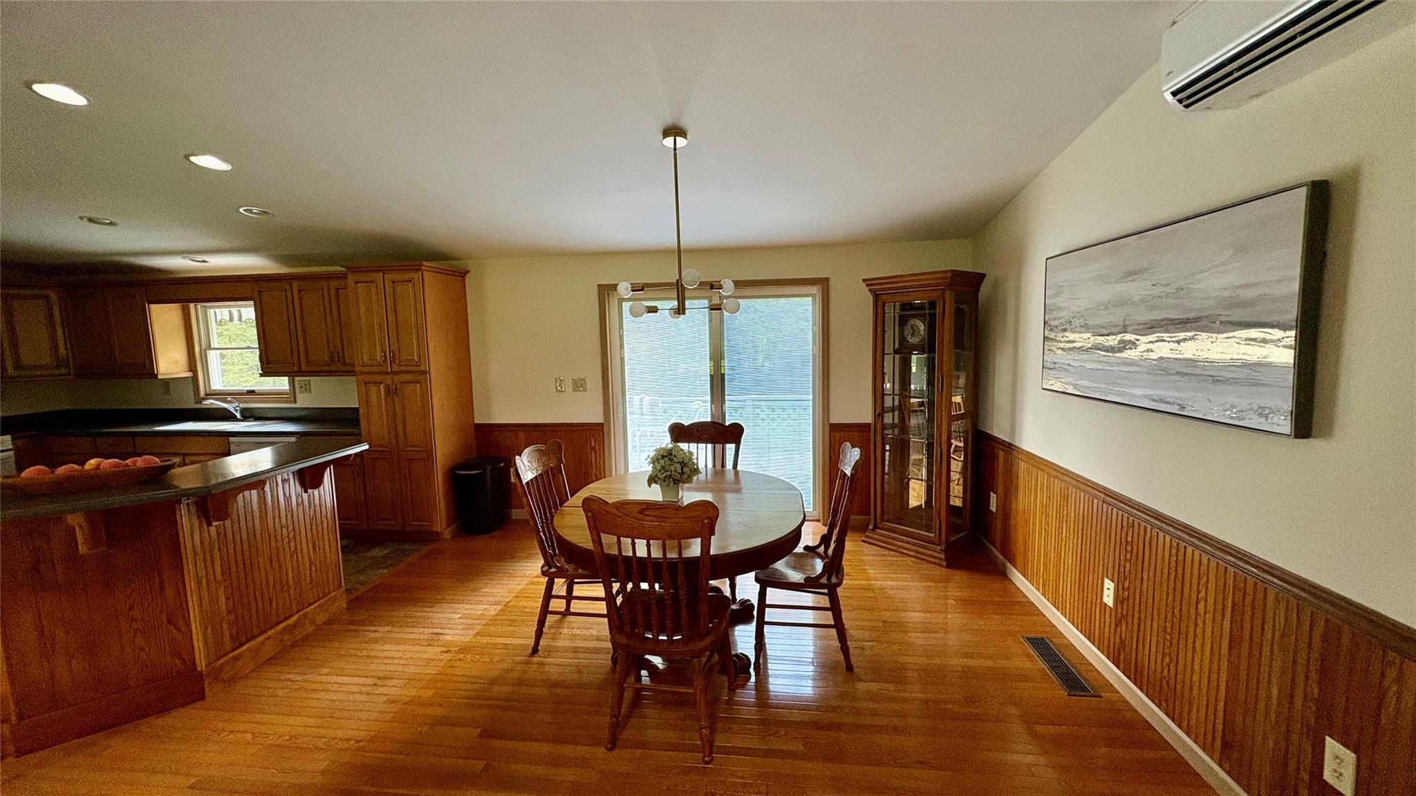 105 White Sulphur Road Swan Lake, NY 12783 - Photo 33 of 42 a dining room with furniture a chandelier and wooden floor