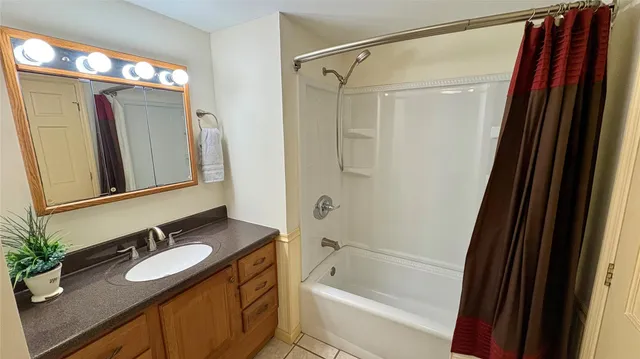 a bathroom with a granite countertop sink mirror vanity and toilet