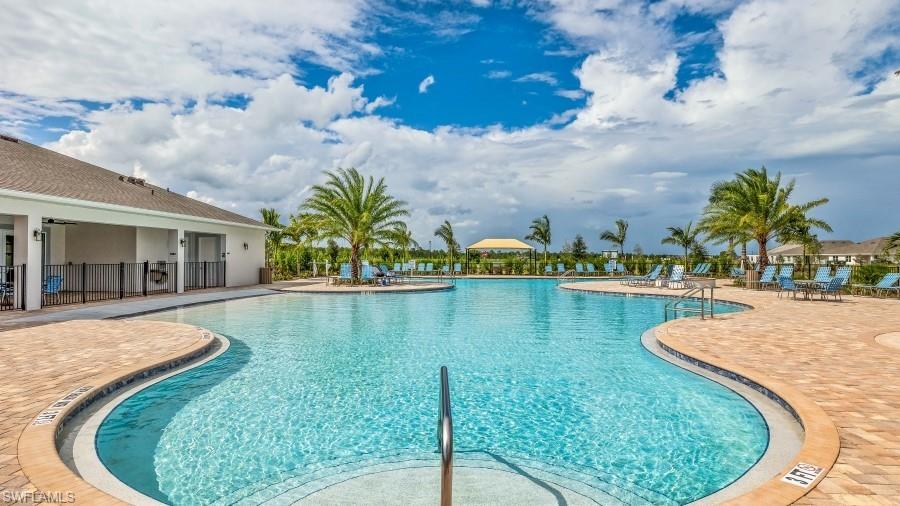 17613 Shade Tree Loop Punta Gorda, FL 33982 - Photo 23 of 27 a view of a swimming pool with a lounge chairs