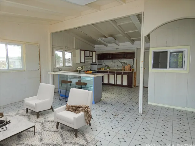 a living room with furniture and a potted plant