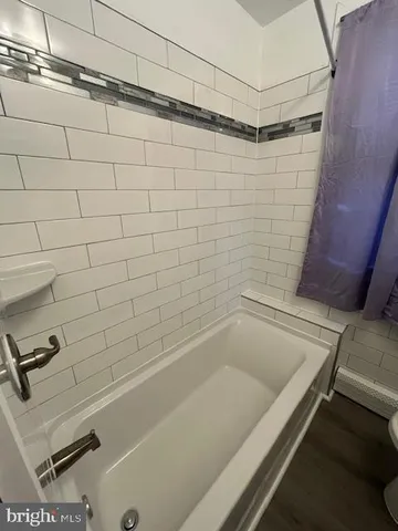 a bathroom with a bathtub and shower