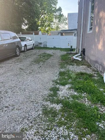 a view of a backyard with parked cars