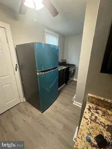a kitchen with a refrigerator and a stove