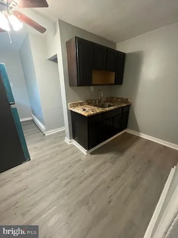 a kitchen with stainless steel appliances wooden cabinets and a stove