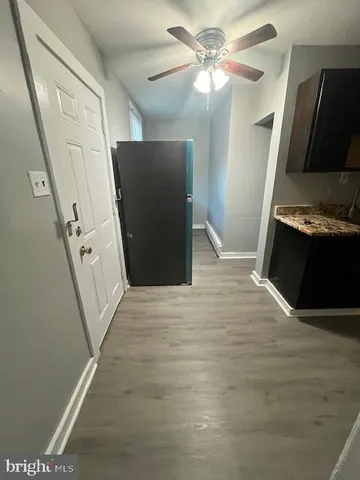 a view of a kitchen with a sink and a refrigerator