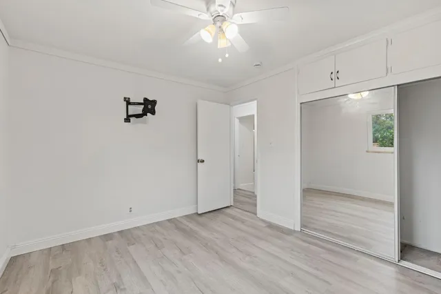 a view of a room with a window and ceiling fan