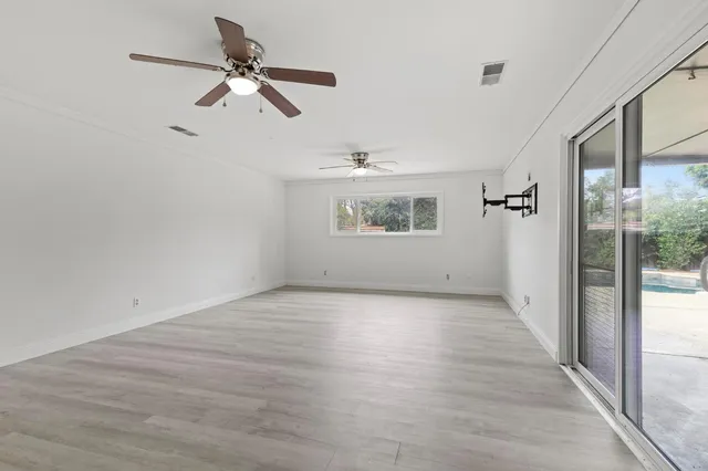 wooden floor in an empty room with a window