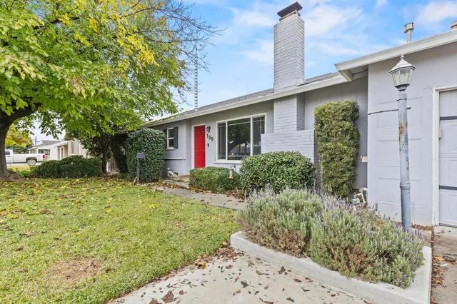 a front view of a house with garden