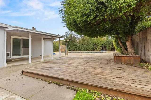 a view of swimming pool and trees in the background