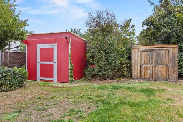 an aerial view of a house with a yard basket ball court and outdoor seating