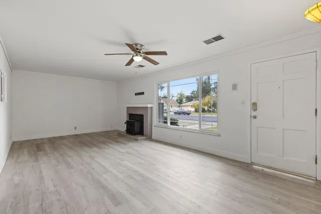 a view of empty room with a fireplace