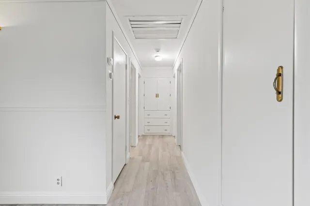 an empty room with windows and closet