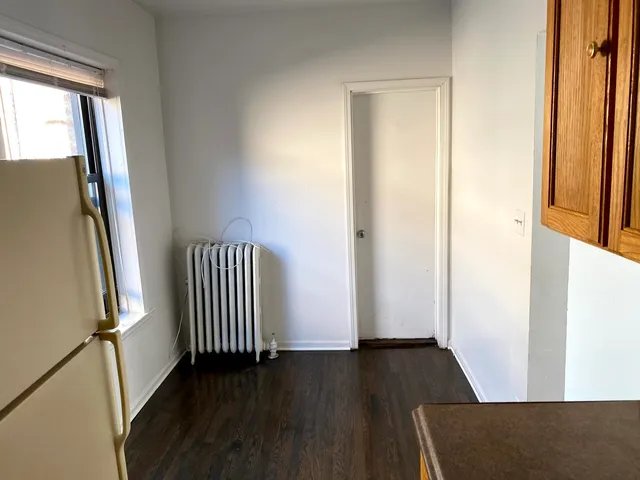 an entryway with wooden floor and staircase