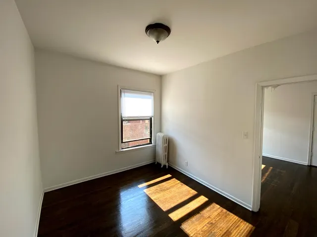 a view of a room with wooden floor and natural light