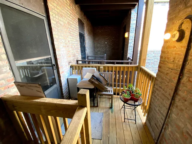 a view of balcony with furniture and wooden floor