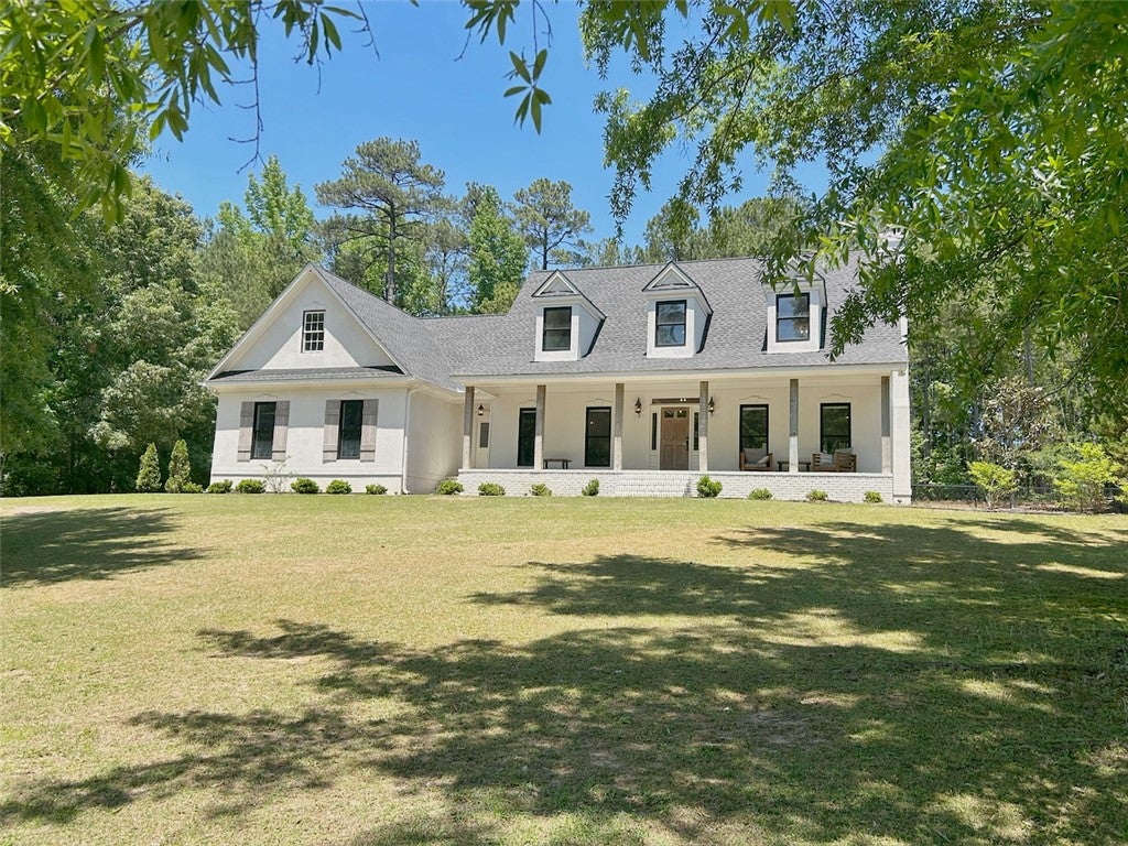 2004 Moores Mill Road Lanett, AL 36863 - Photo 1 of 50 This elegant residence offers a classic facade with a welcoming front porch, perfect for outdoor living.