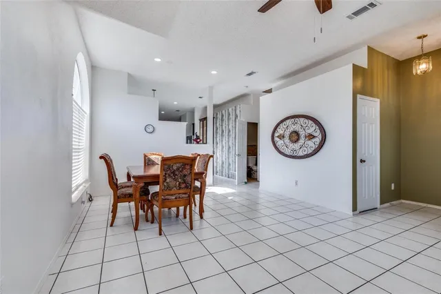 a view of a dining room with furniture and chandelier