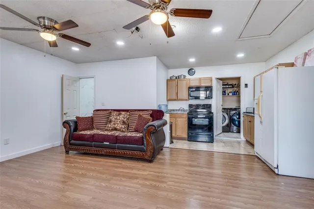 a living room with furniture and kitchen view