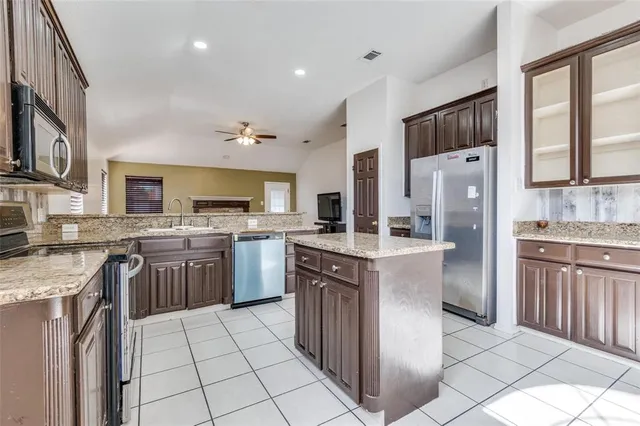 a kitchen with a sink stove and refrigerator