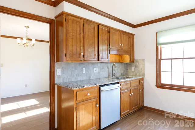 a kitchen with stainless steel appliances granite countertop cabinets and window