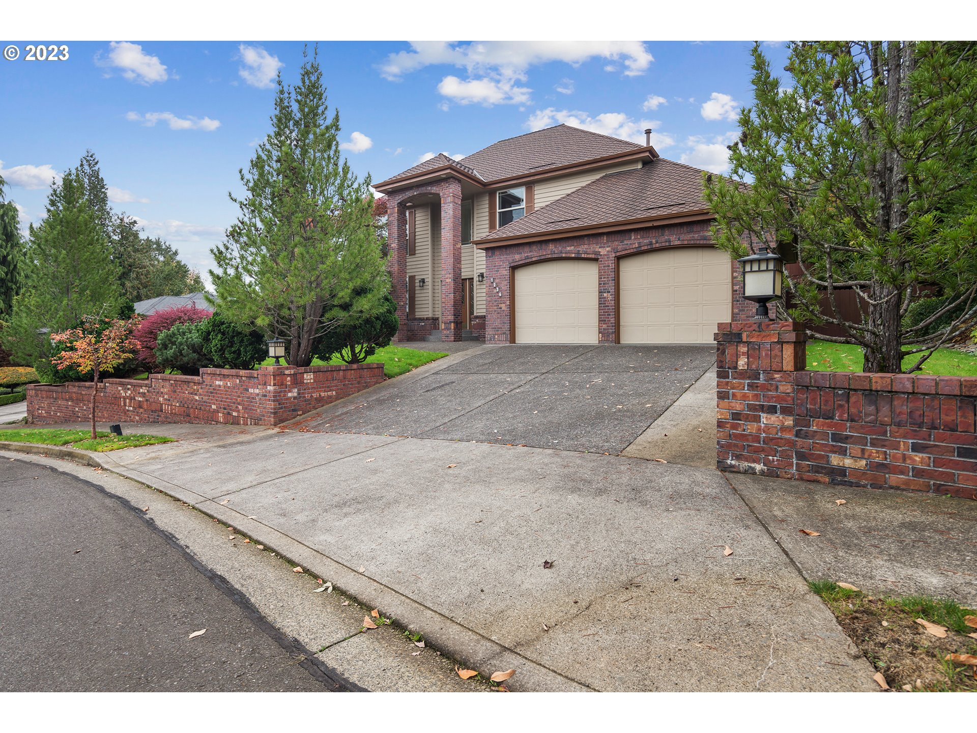 a view of a house with a yard and garage
